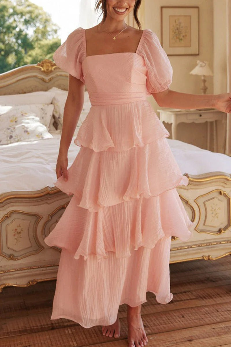 Multi-layered cake skirt with square neckline, open back, and ruffled details.